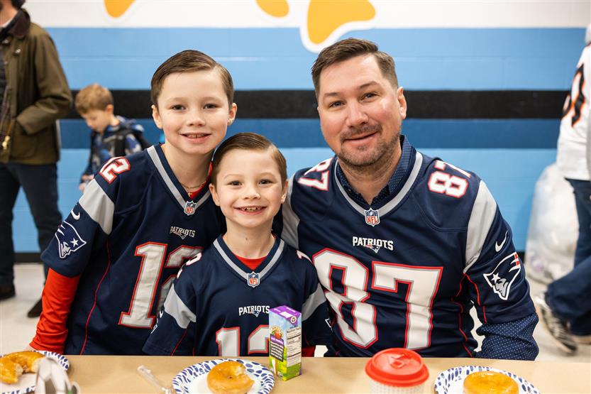 Trinity Elementary students eat donuts with dudes
